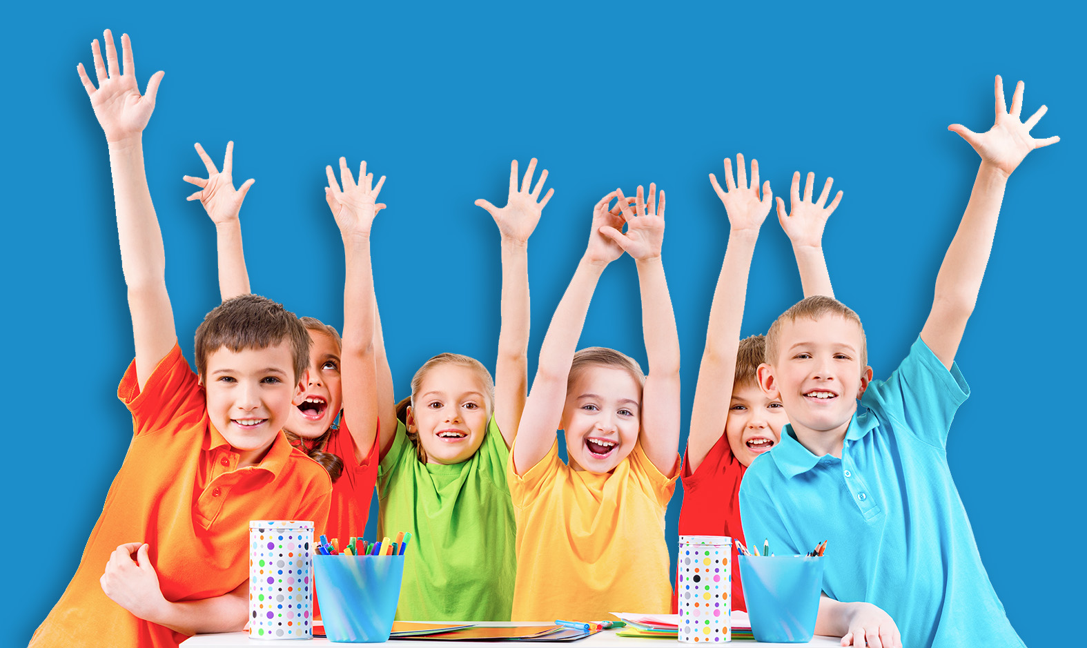 Group of children in colored t-shirts with raised hands.