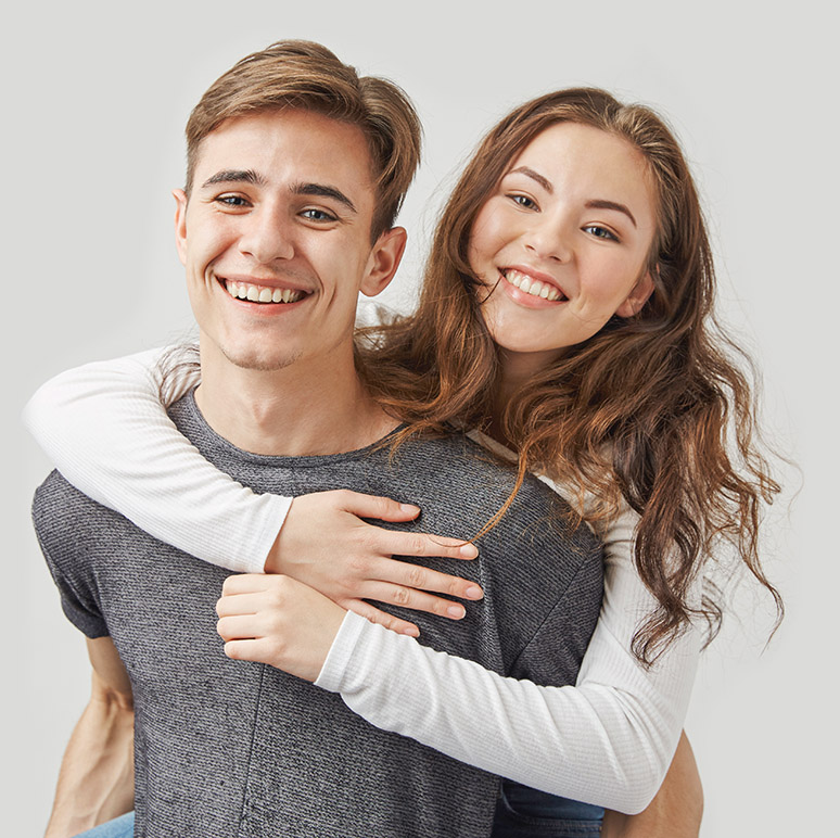 Couple hugging and laughing near the wall. Nobody believed in their relationship. Look who was wrong. Happy anniversary to this two young cuties in love. Maybe wedding is also very close